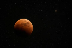 Late August Skies: A Near-Total Lunar Eclipse, Saturn’s Moons in Motion, and the Helix Nebula